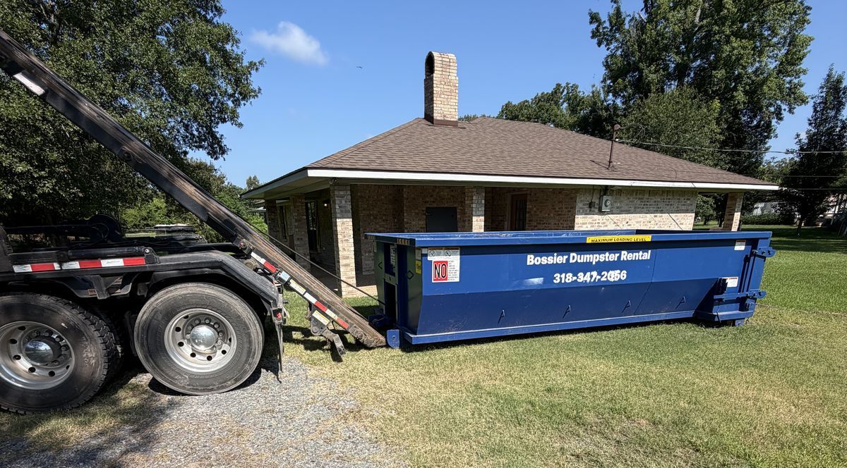 Bossier Dumpster Rental container being set down beside a home